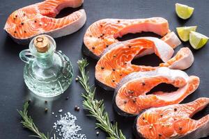 Raw trout steaks on the wooden board photo