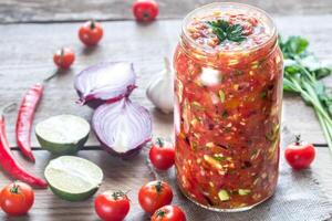 Jar of salsa with ingredients photo