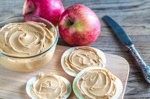 Slices of apples with peanut butter photo