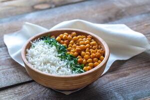 Bowl of chickpea curry with white rice and fresh cilantro photo