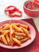 Penne with tomato sauce and fresh red pepper photo