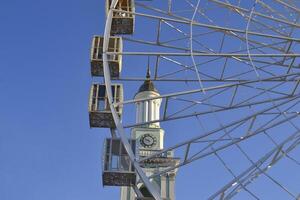 Ferris wheel against a blue sky background. photo