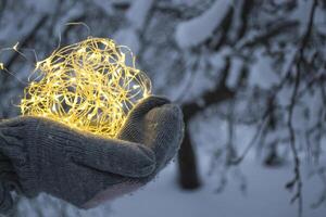 The festoon lights in hands outdoor. photo