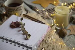 A cup of tea and decor on the table. Hygge style. Winter still life. photo