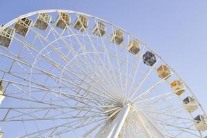 Ferris wheel against a blue sky background. photo