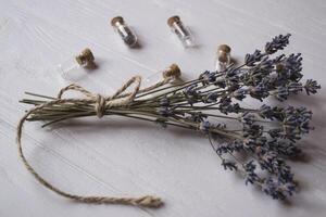 Glass bottles and lavender on a table. photo