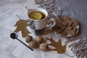 A cup of tea with lemon and cakes. Hygge flat lay. photo