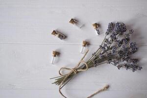 Glass bottles and lavender on a table. photo