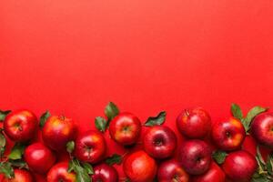 Many red apples on colored background, top view. Autumn pattern with fresh apple above view with copy space for design or text photo