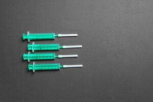 Top view of different syringes for injection on colorful background. Medical equipment concept with copy space photo