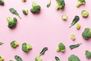 Flat lay composition with fresh green broccoli frame eith copy space on light background photo