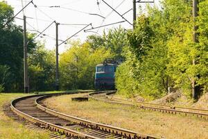 Old blue train is arriving at the platform at the railway station photo