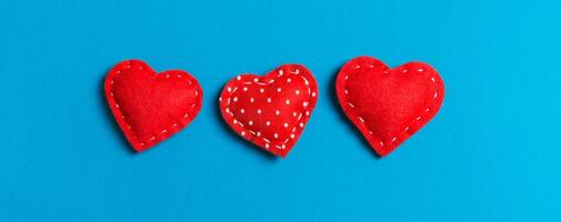 Top view of textile hearts on colorful background. Valentine's day concept with copy space photo