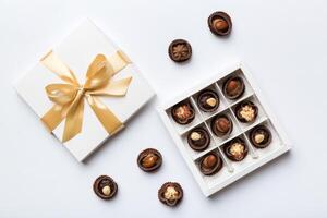 White box with chocolates candies and golden tape. top view with copy space photo