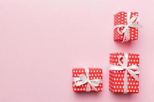 Valentine day composition red gift box with bow and heart. Christmas present. View from above. Space for text. Holday greeting card photo