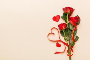 Valentine day composition with rose flower and red heart on table. Top view, flat lay, copy space Holiday concept photo