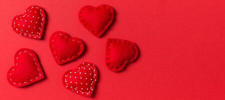 Composition of textile red hearts on colorful background. Close up view. Top view of St. Valentine's day concept photo