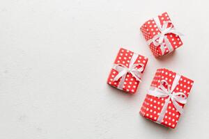 Valentine day composition red gift box with bow and heart. Christmas present. View from above. Space for text. Holday greeting card photo