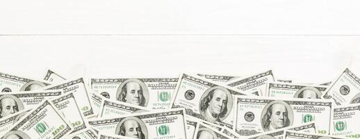 Top view banknotes on colored desk with copy space on top. one hundred dollar bills with stack of money in the middle. Top view of business concept photo