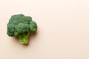 Top view fresh green broccoli vegetable on Colored background. Broccoli cabbage head Healthy or vegetarian food concept. Flat lay. Copy space photo