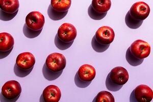 Many red apples on colored background, top view. Autumn pattern with fresh apple above view photo