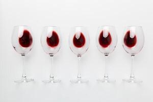 Many glasses of red wine at wine tasting. Concept of red wine on colored background. Top view, flat lay design photo