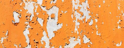 Texture of bright orange paints shabby metal wall photo