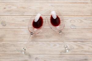 Many glasses of red wine at wine tasting. Concept of red wine on colored background. Top view, flat lay design photo