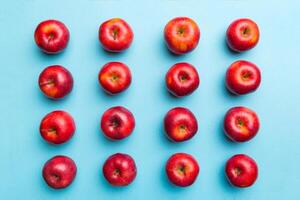 Many red apples on colored background, top view. Autumn pattern with fresh apple above view photo