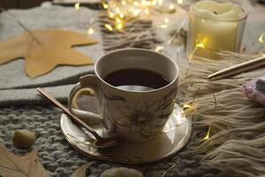 A cup of tea and decor on the table. Hygge style. Winter still life. photo