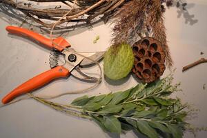 Dried flowers on a desk. The tools for decoration. photo