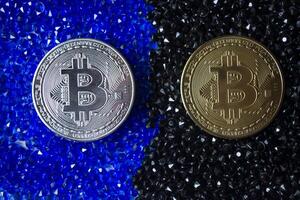 Golden and silver bitcoin on a rhinestones. photo