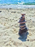 A group of sea stones on the sand near sea. photo