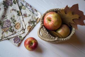 Red apples in a basket on a table. photo