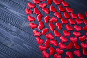 Red love hearts on a blue wooden background. Valentine's Day 2019. Background for greeting card. photo