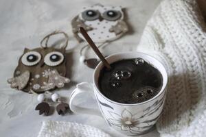 A cup of coffee, woolen sweater and Christmas decorations. Winter still life. photo