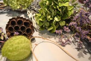 Dried flowers on a desk. The tools for decoration. photo