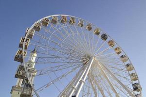 Ferris wheel against a blue sky background. photo
