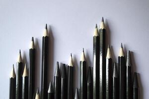 The set of grey pencils on a white background. Tools for drawing on the desk. photo