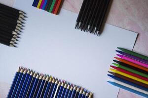 The set of pencils and white paper on the table. photo