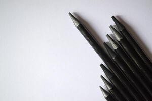 The set of grey pencils on a white background. Tools for drawing on the desk. photo