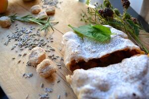 The strudel with decoration on a wooden board. Beautiful tasty dessert. photo