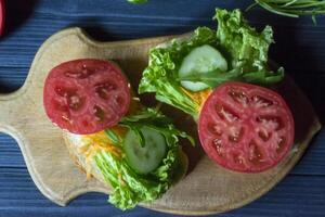 el emparedados con vegetales en un tablero. vegetariano alimento. ingredientes para Cocinando en el mesa. foto