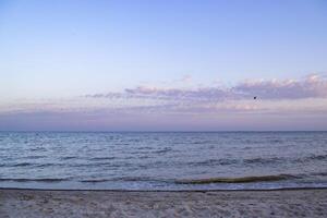 Beautiful sunset on the deserted beach. The place for rest and relaxation. photo