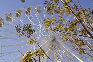 Ferris wheel against a blue sky background. photo