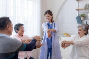 Portrait of elderly smiling Asian woman and people aerobics in nursery house. Seniors are moving their body arms and shoulders for a healthy life. retired people activities group concept. photo