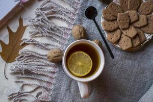 A cup of tea with lemon and cakes. Hygge flat lay. photo