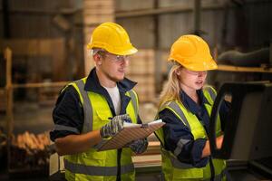 actory engineer workers standing to control panel switch. people works at heavy machine at industry factory. with machinery equipment plant technology. smart industry worker operating. photo