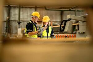 actoria ingeniero trabajadores en pie a controlar panel cambiar. personas trabajos a pesado máquina a industria fábrica. con maquinaria equipo planta tecnología. inteligente industria trabajador operando. foto