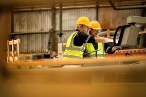 actory engineer workers standing to control panel switch. people works at heavy machine at industry factory. with machinery equipment plant technology. smart industry worker operating. photo